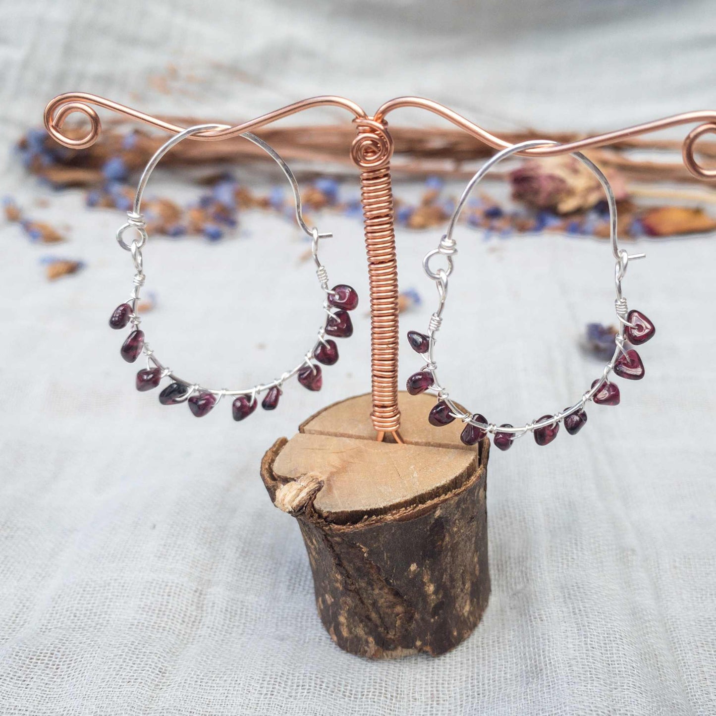handwoven red garnet hoop earrings in silver filled wire hanging