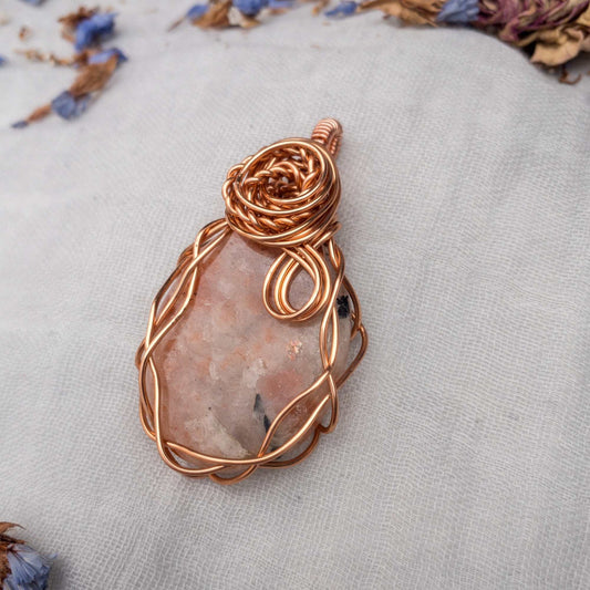large sunstone wire wrapped in copper wire with rose wrap decal