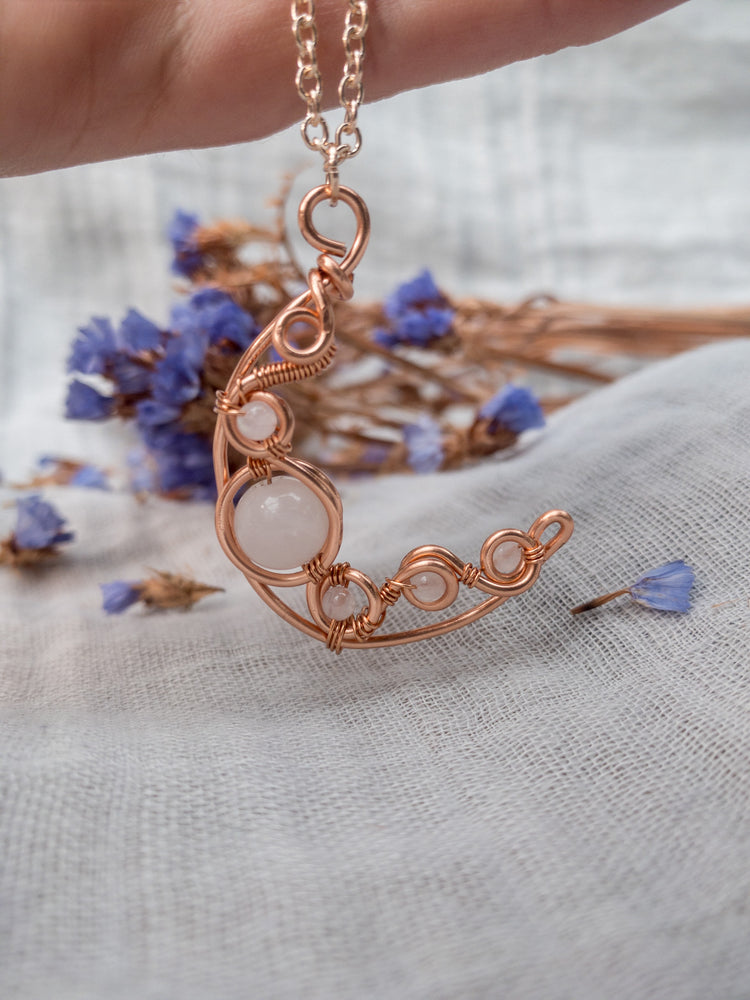 Copper wire wrapped crescent moon with rose quartz beads 